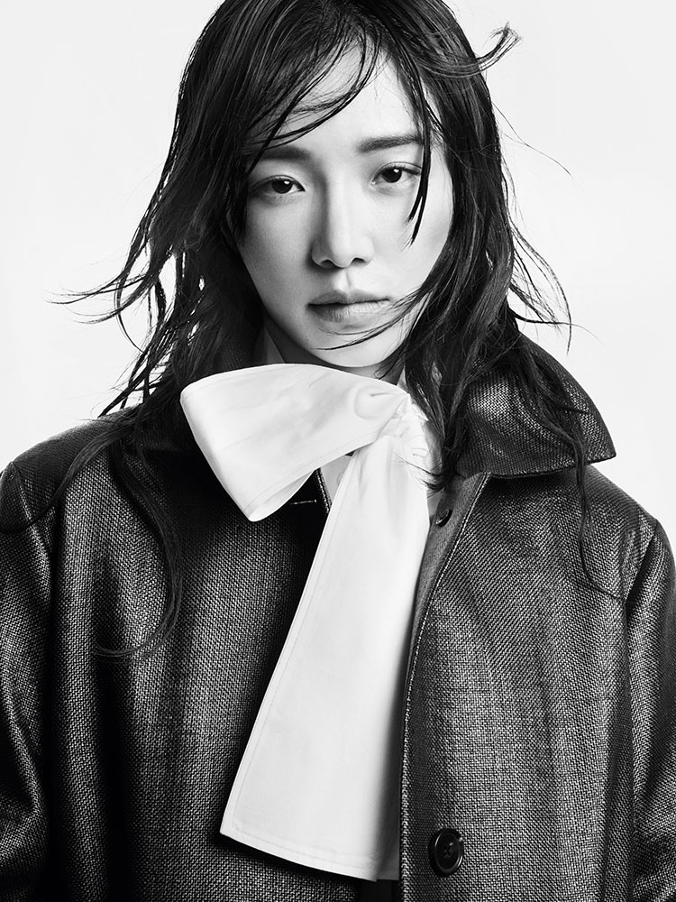 man wearing turtleneck standing on balcony